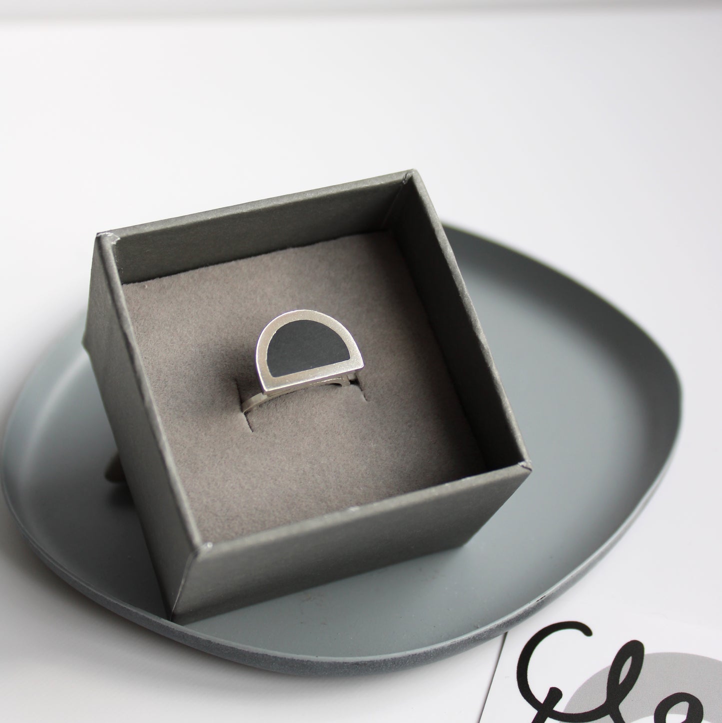 black and silver ring in box