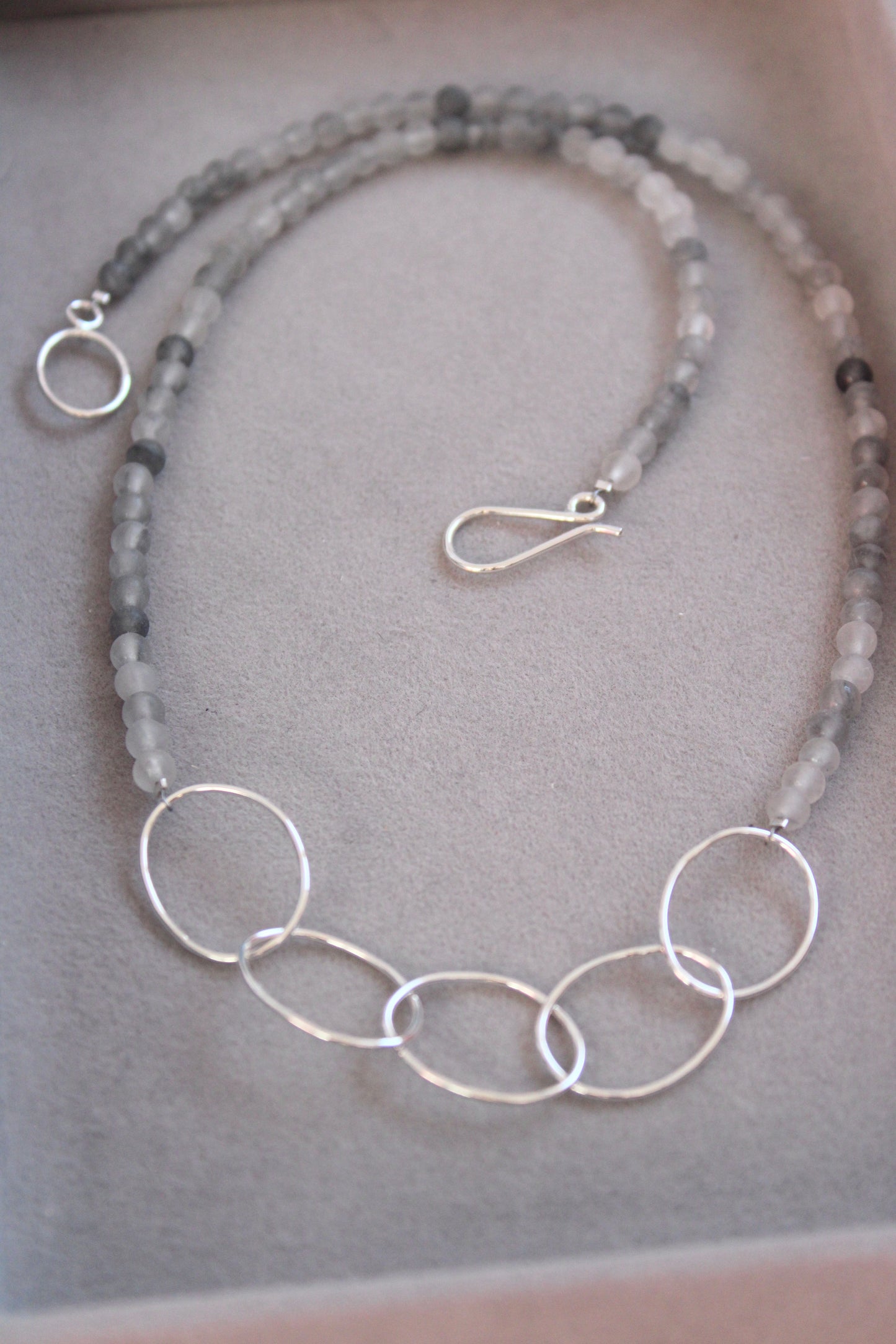 close up of silver pebble and agate necklace