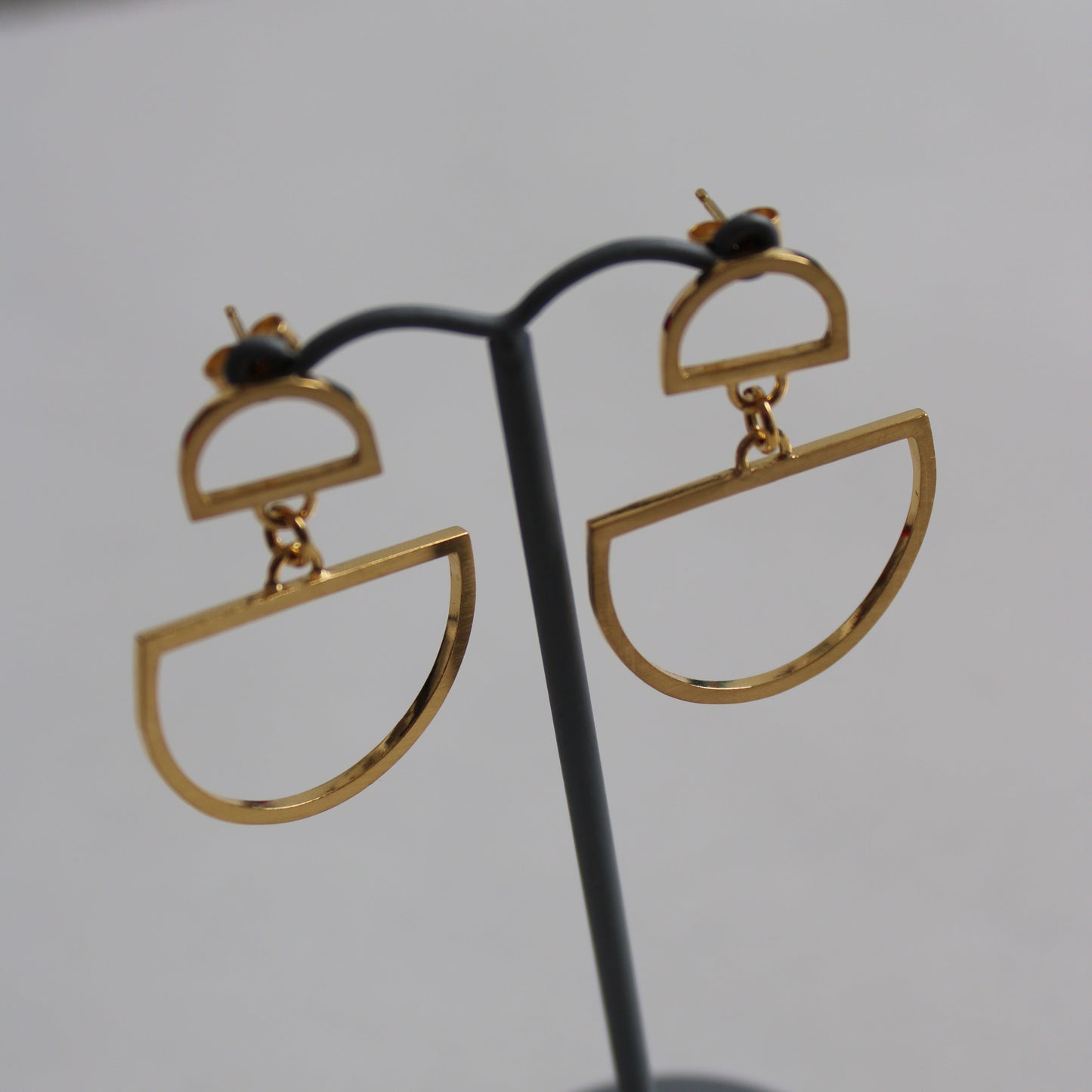 gold double arc studs on earring stand