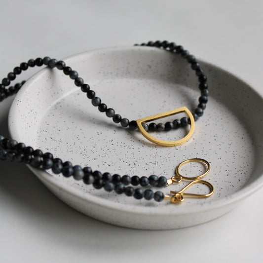snowflake obsidian bead necklace with gold arc details and clasp