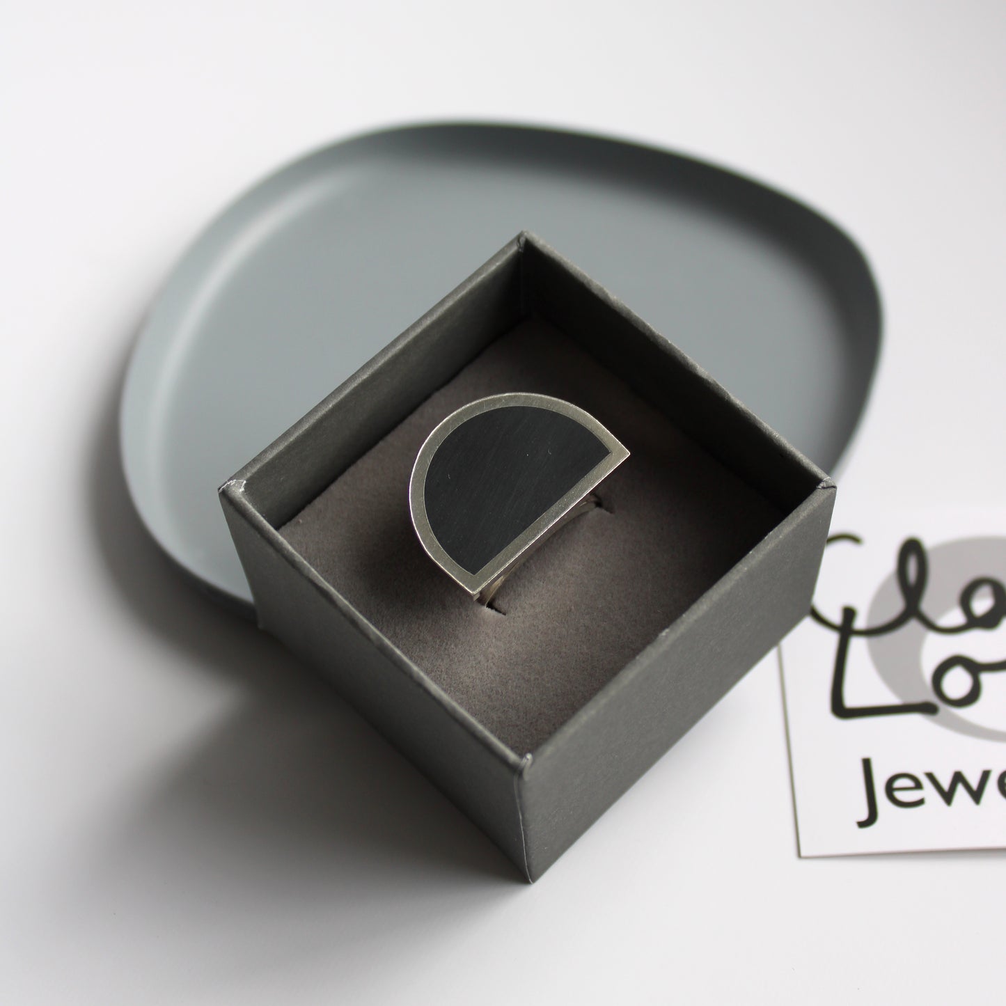 silver and black resin ring
