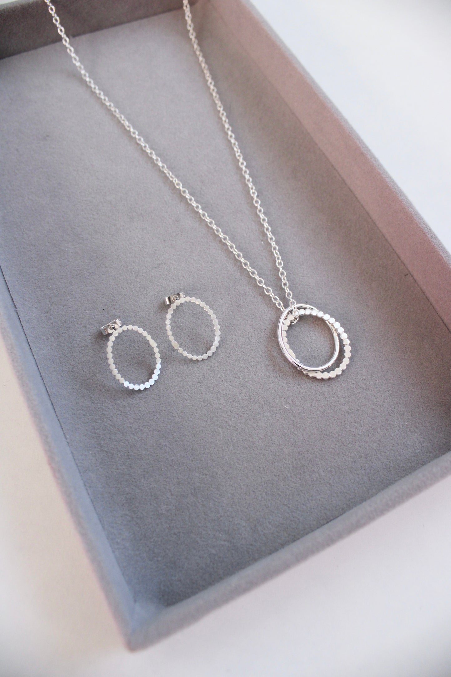 silver dotty oval stud earrings with double pebble pendant