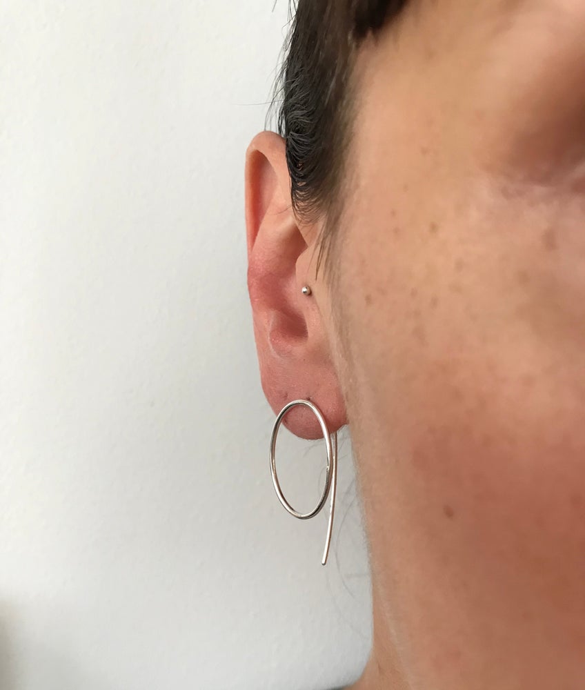 silver oval threader earrings worn