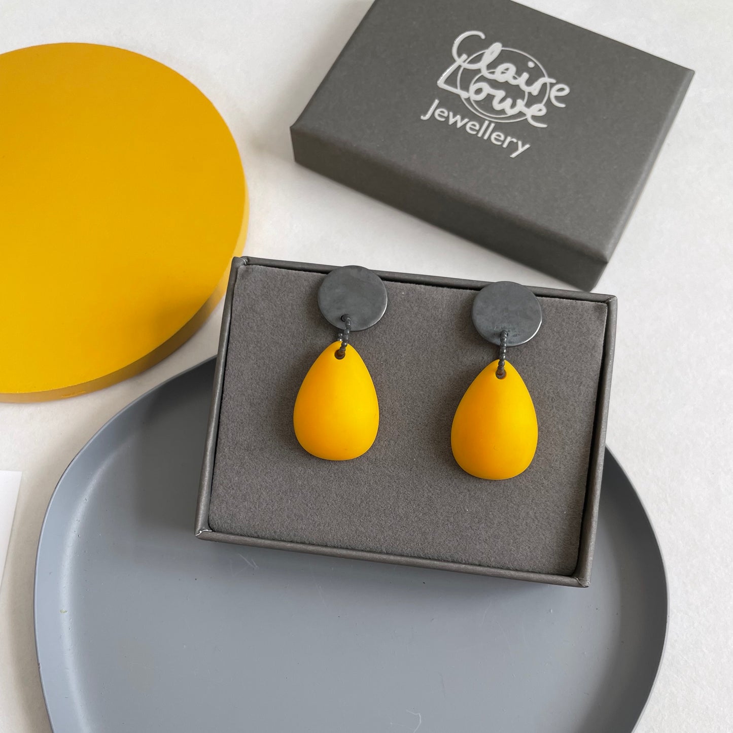 yellow teardrop earrings in a box