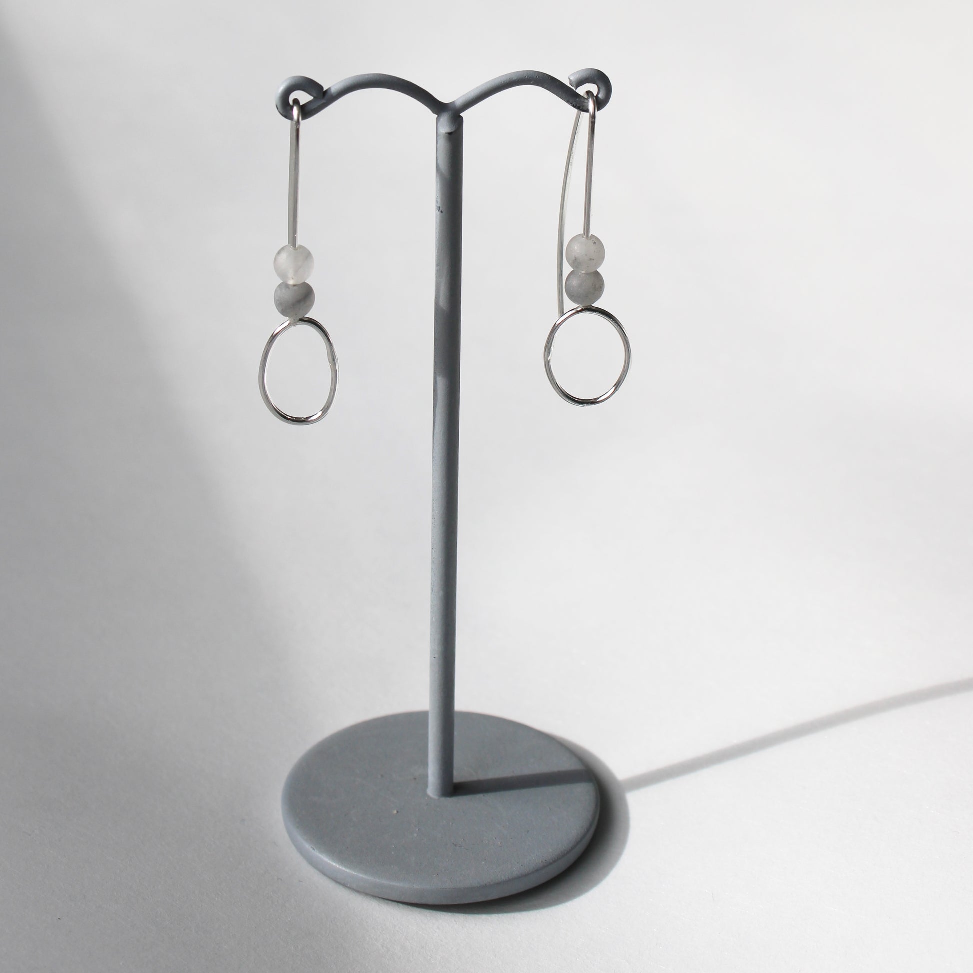 agate bead and silver drop earrings on earring stand