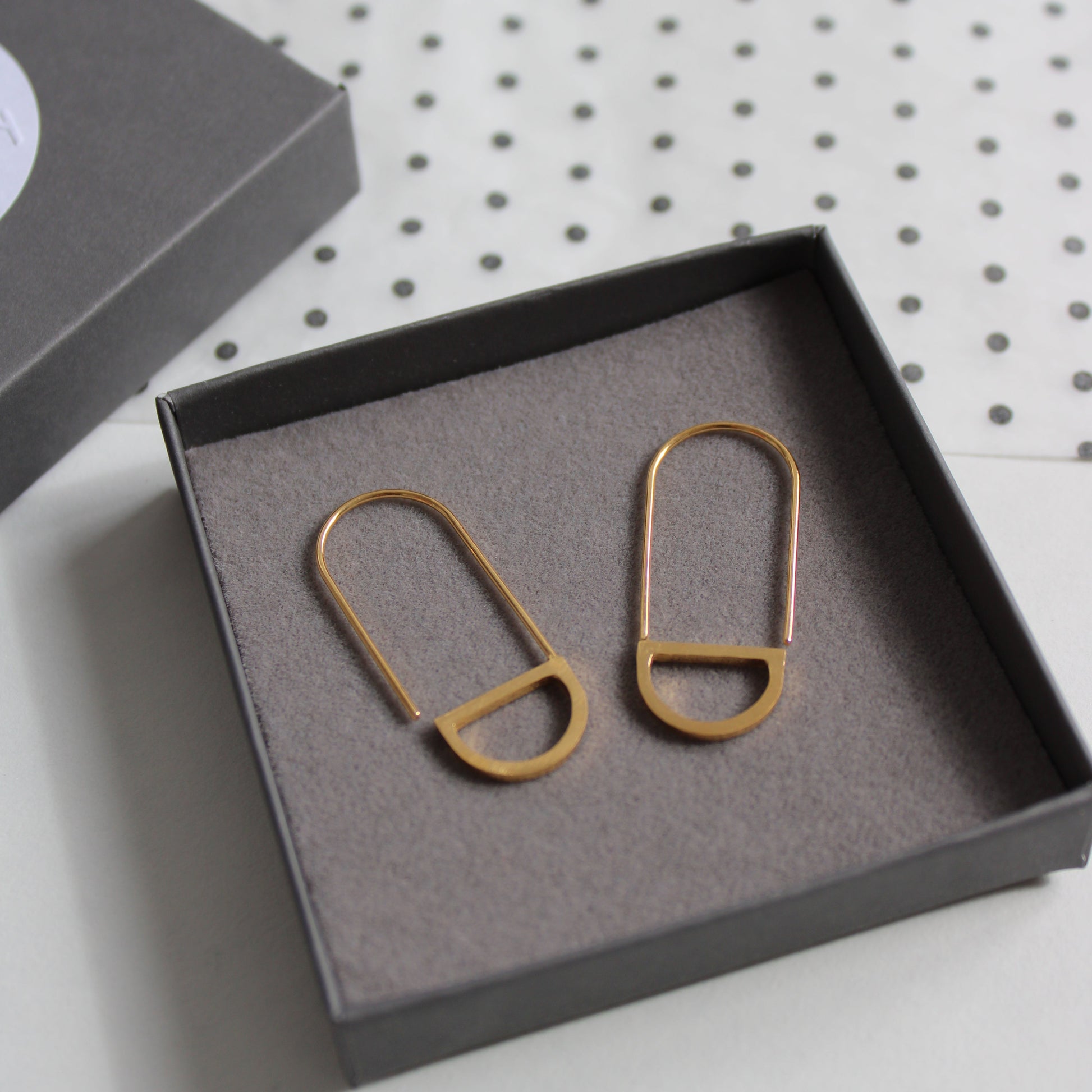 arc loop earrings gold in a box