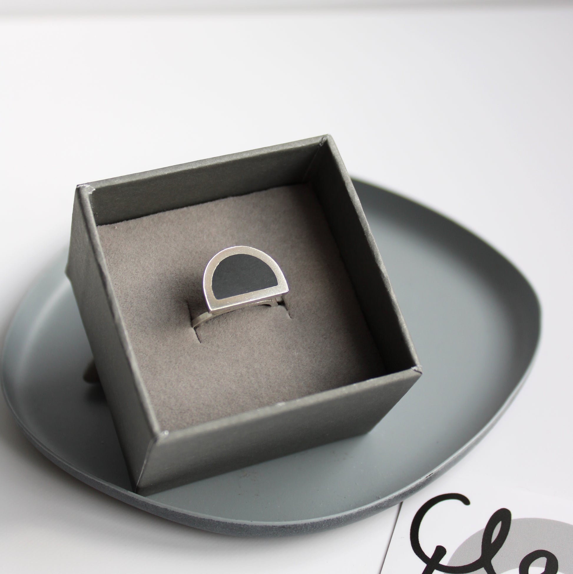 black and silver ring in box