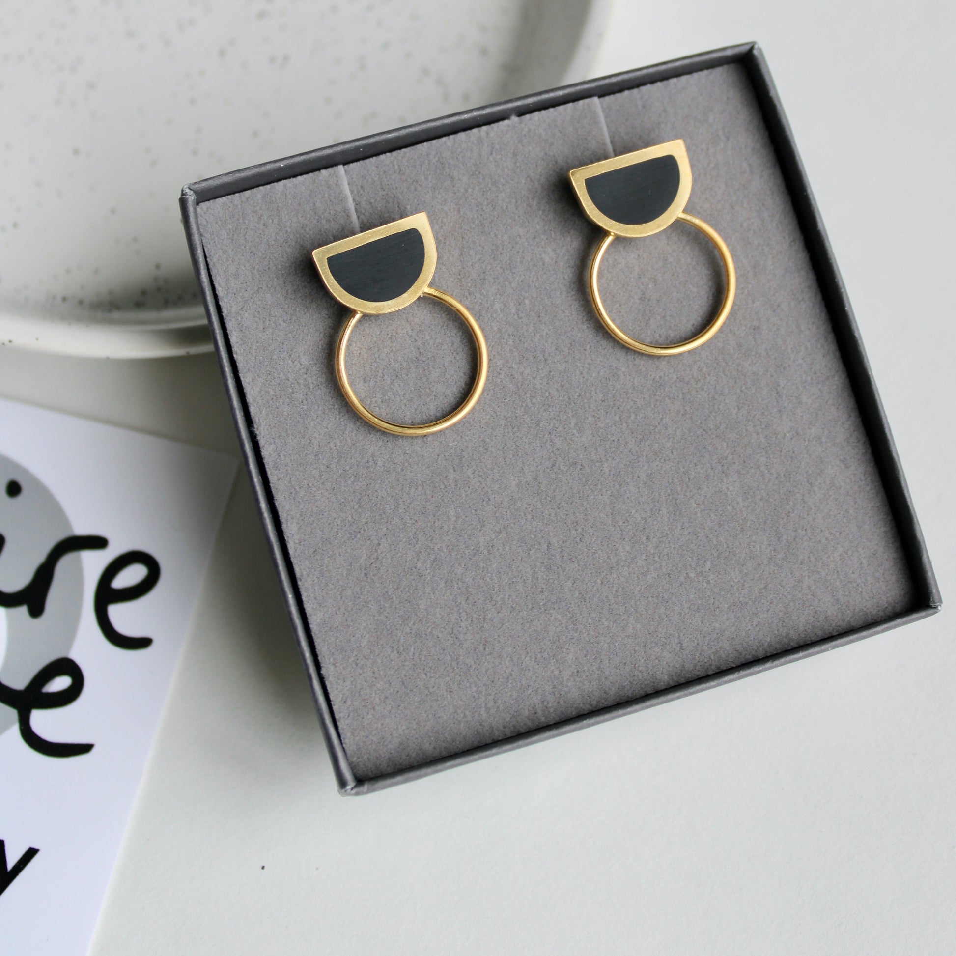 black arc and gold circle stud earrings