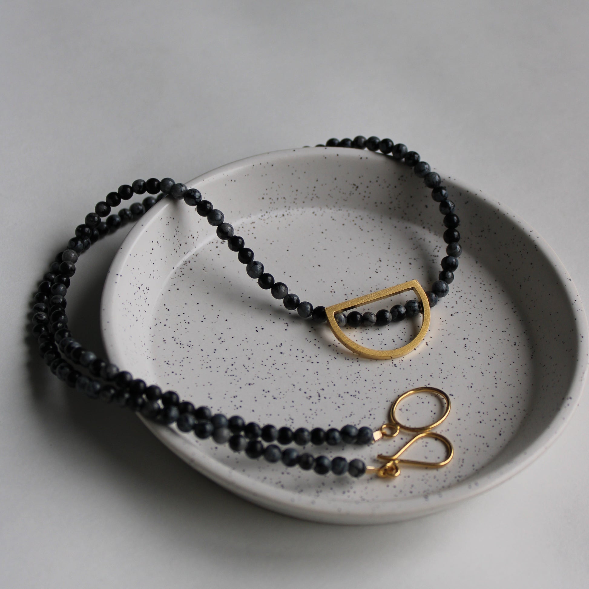 black bead necklace with gold details