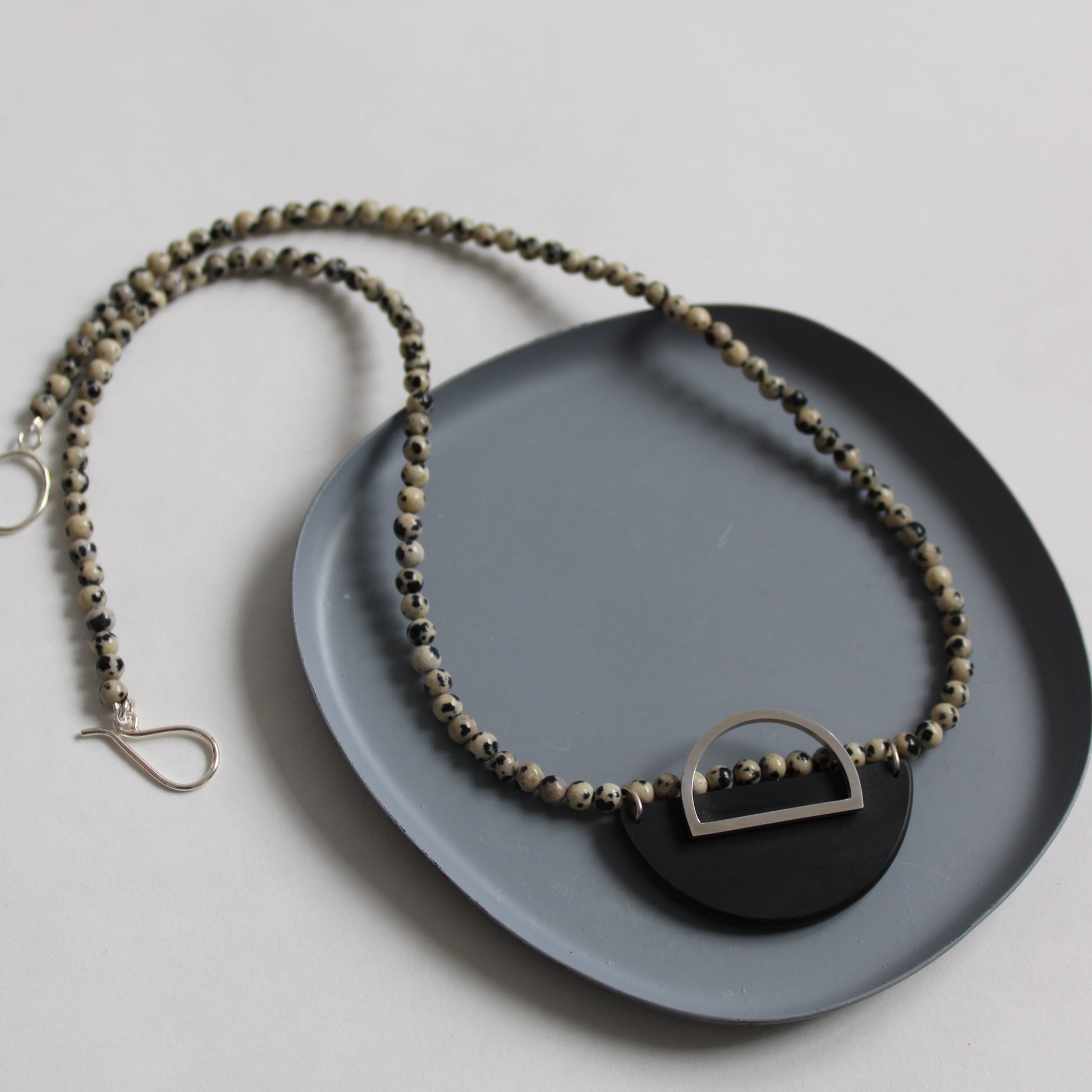 dalmatian jasper bead necklace with black resin and silver arc detail