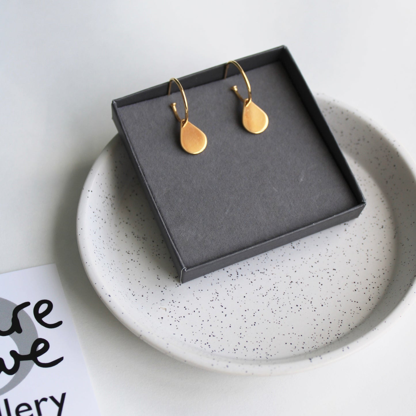 gold teardrop hoop earrings in box