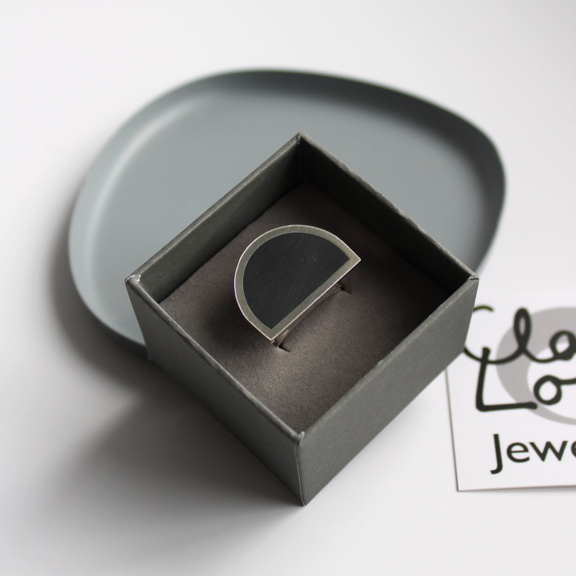 silver and black resin ring
