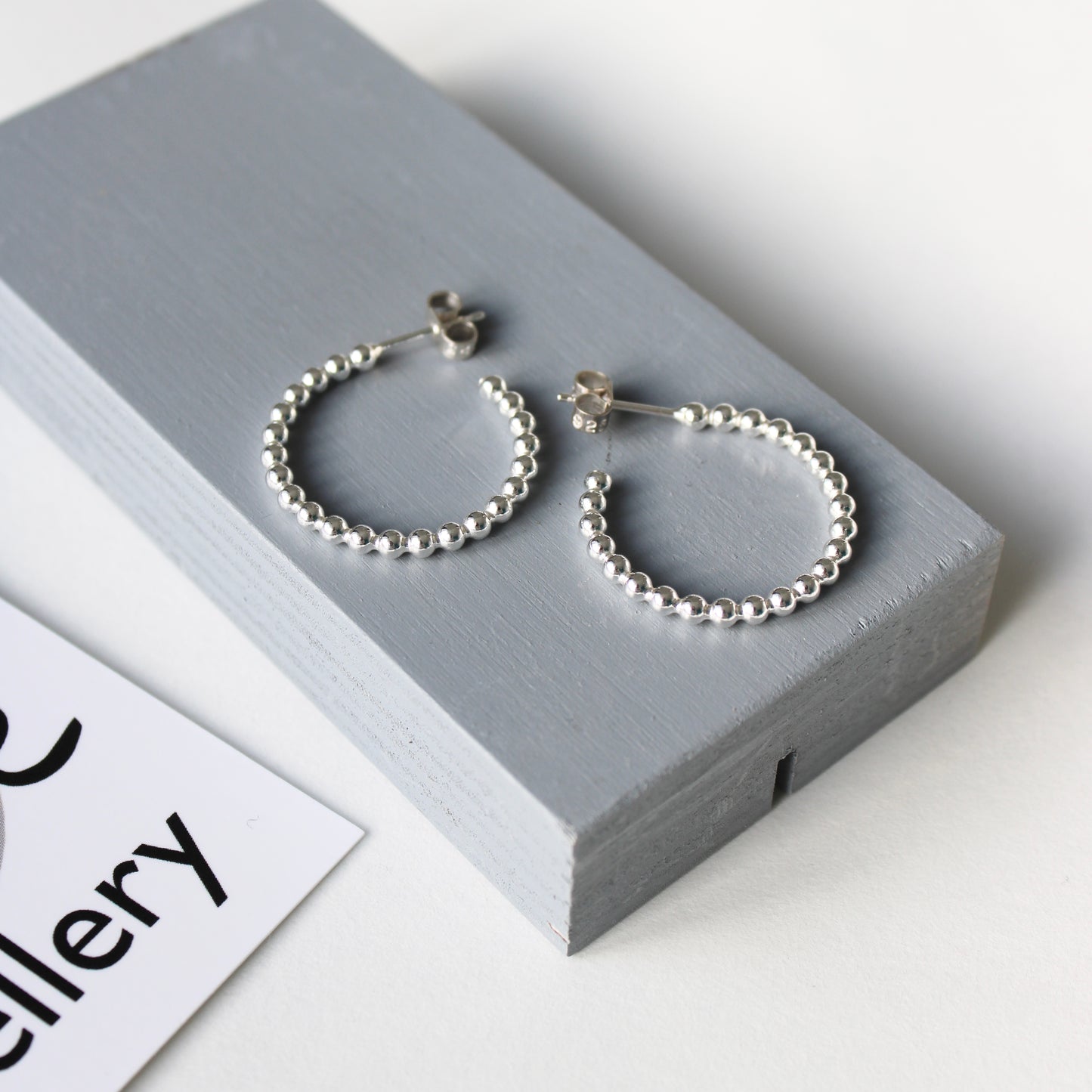 silver dotty medium hoop earrings