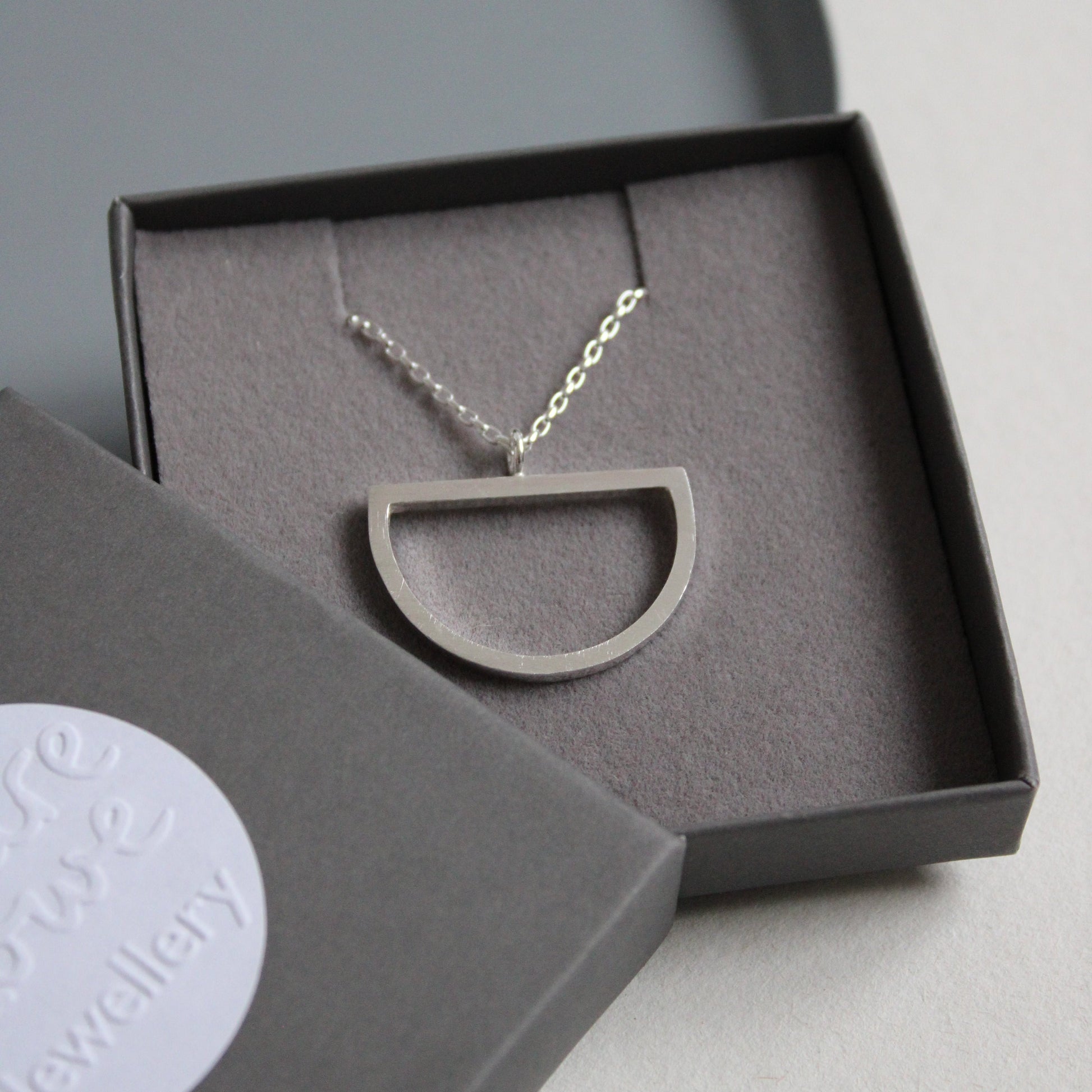 silver large arc pendant in box
