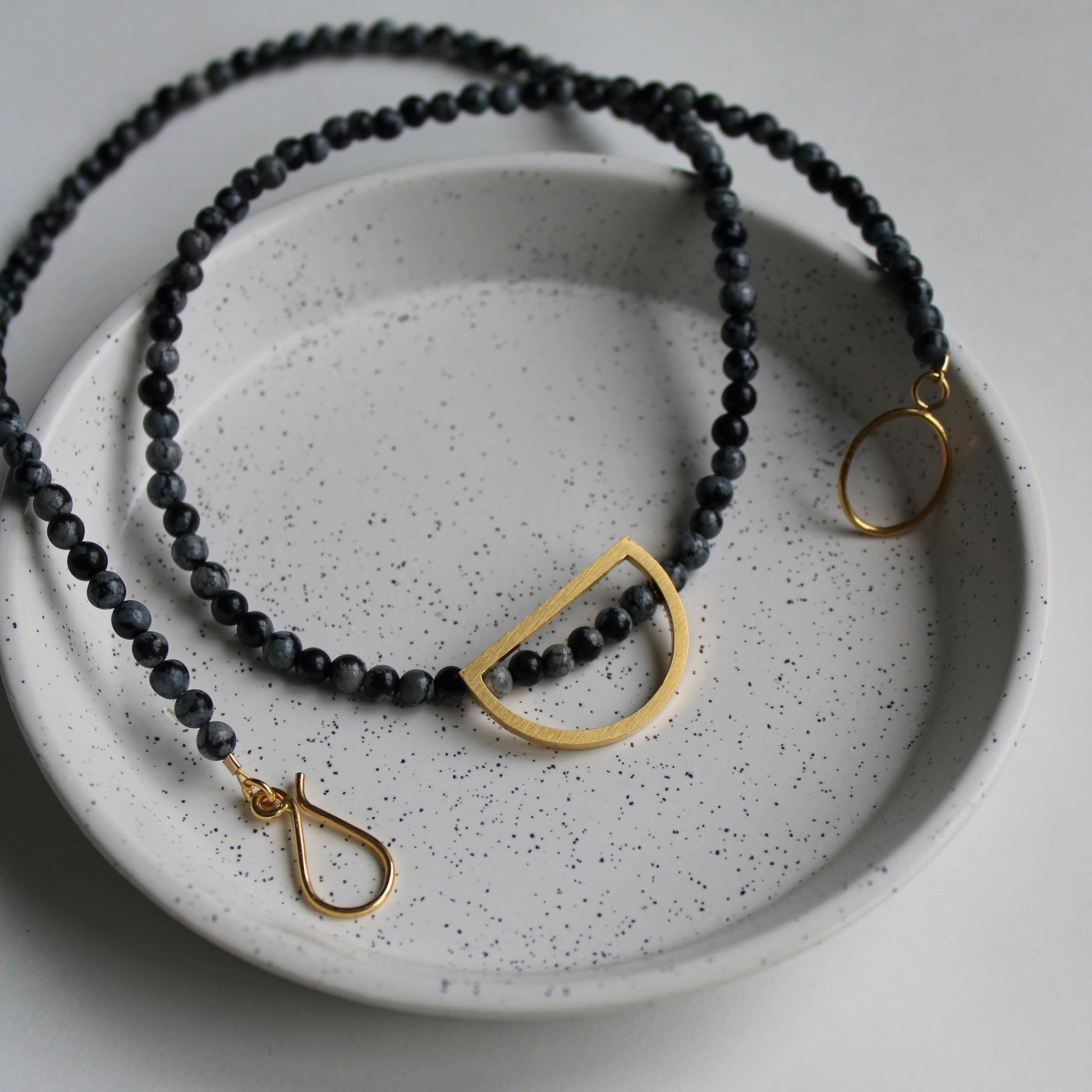 snowflake obsidian bead necklace with gold details