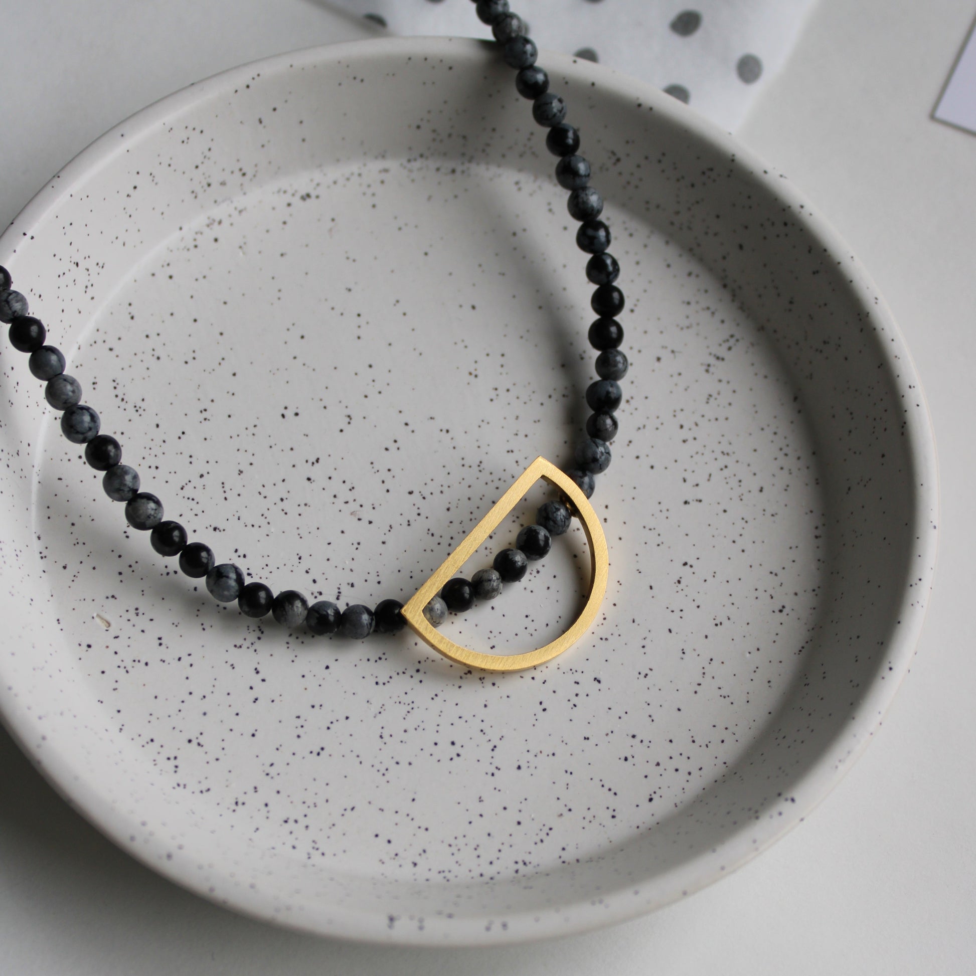 snowflake obsidian bead necklace with gold arc 