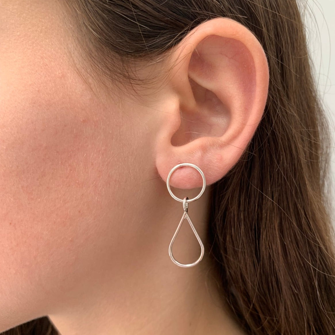 circle and teardrop earrings worn