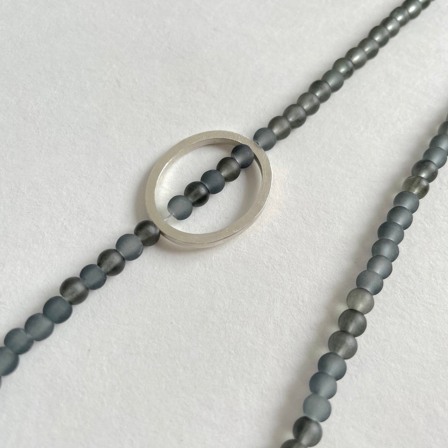 Grey Glass Bead Necklace with a Silver Pebble