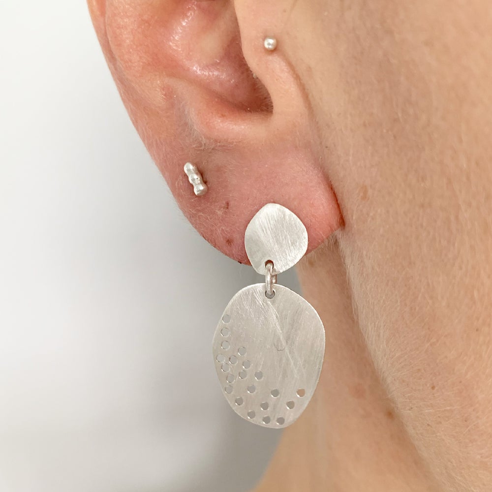 double drilled pebble earrings worn