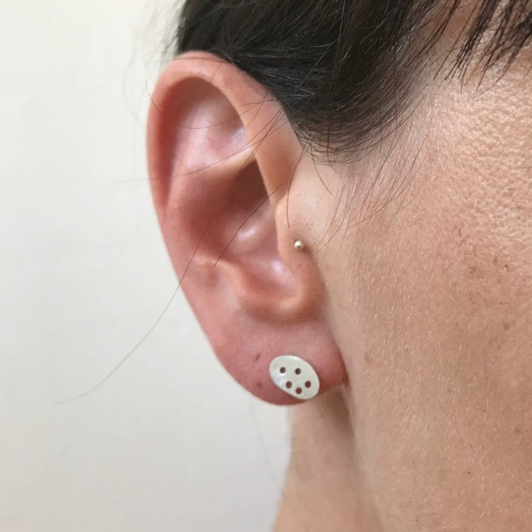 drilled pebble studs worn