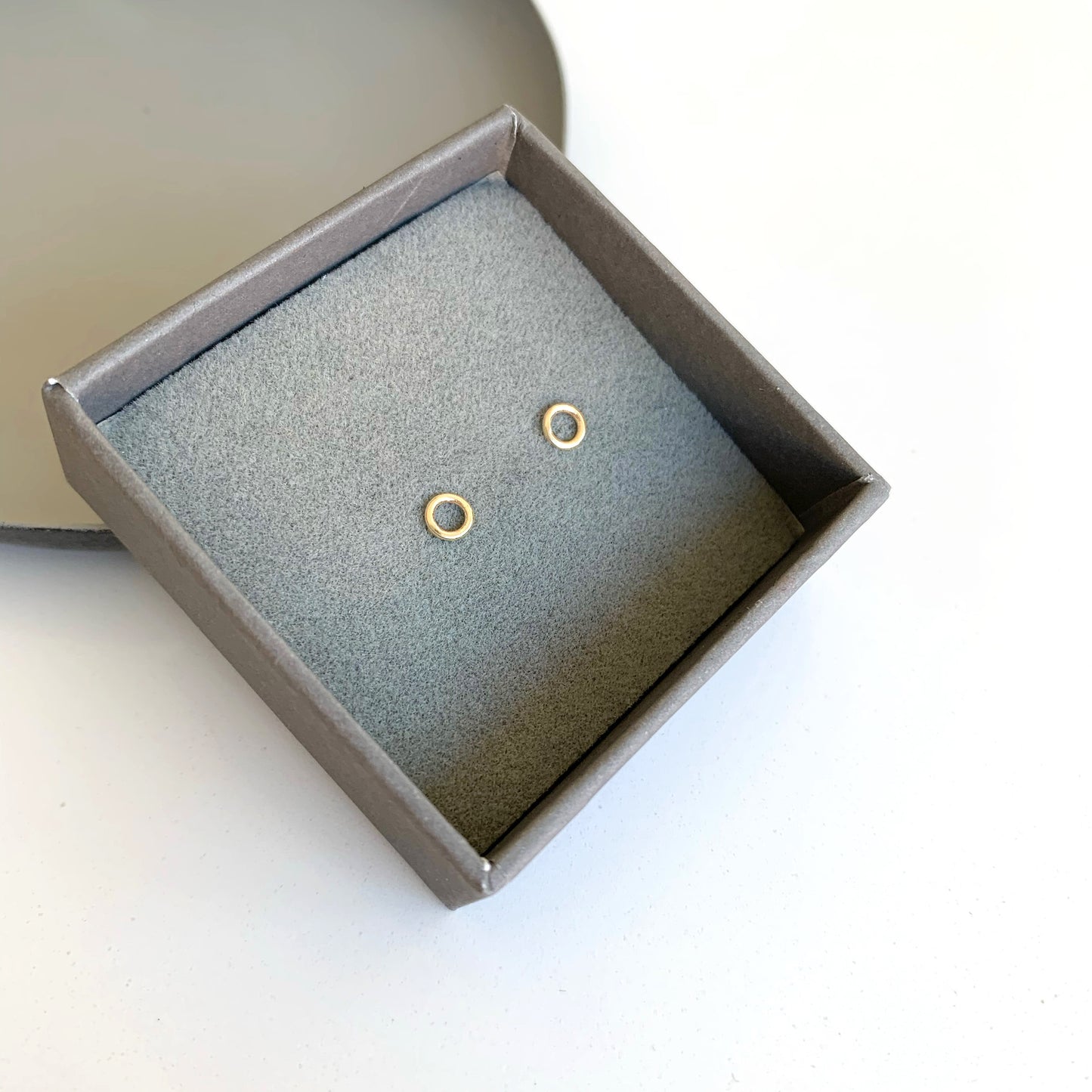 gold circle stud earrings in box