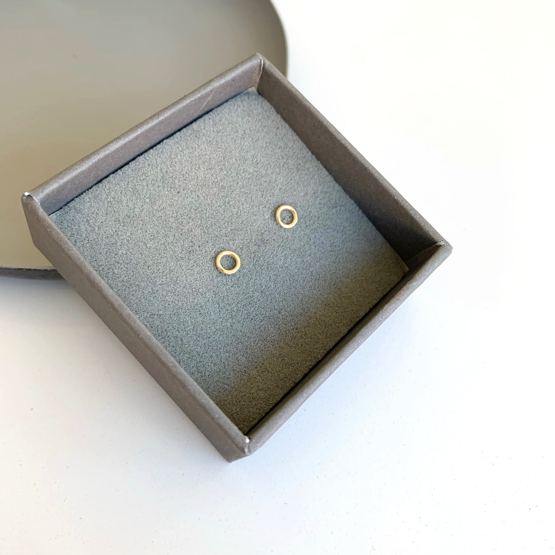 gold circle stud earrings in box