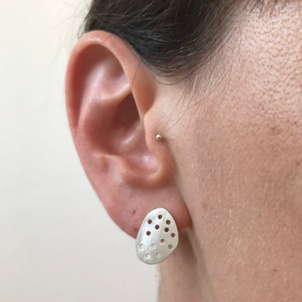 large drilled pebble studs worn