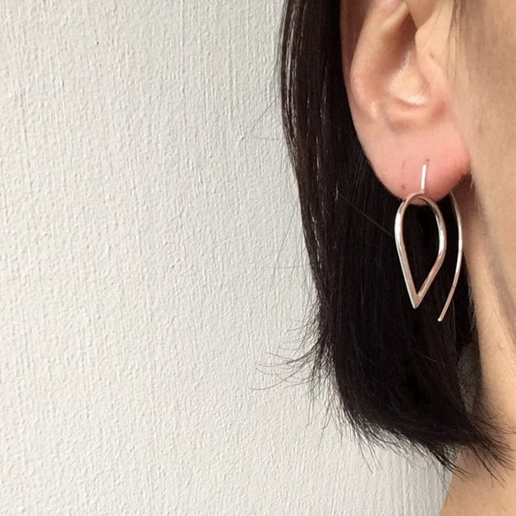 silver flat teardrop earrings worn
